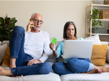 Older couple on phone and computer